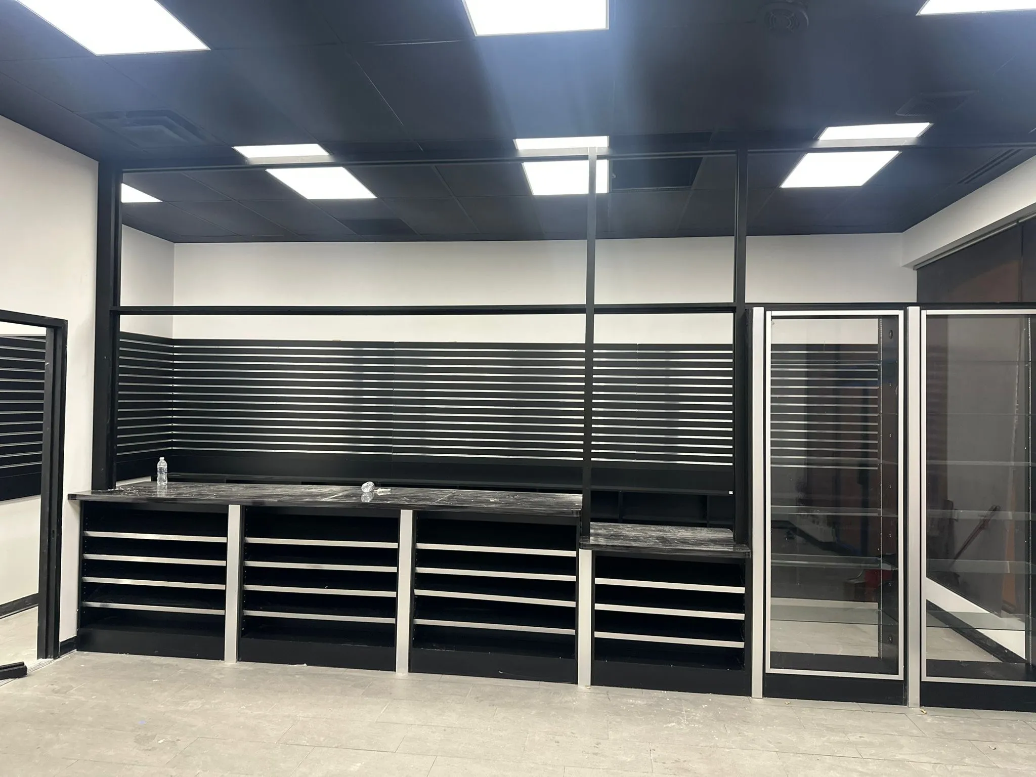 Custom black retail display shelving with glass shelves