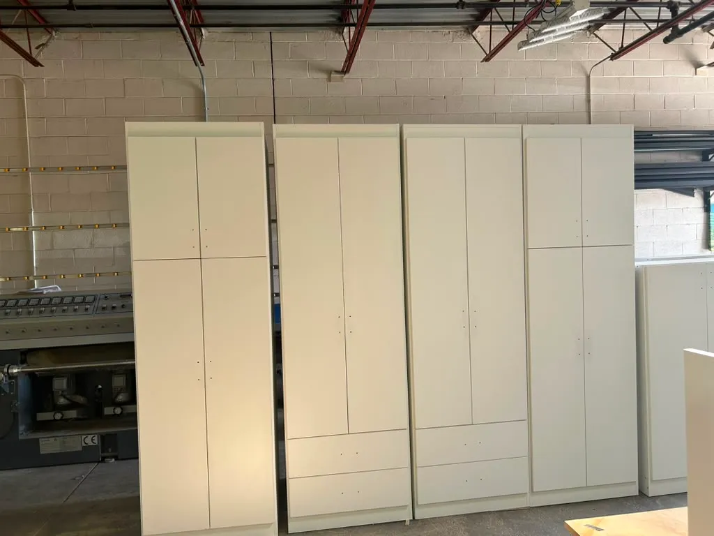 Bank of custom closet wardrobe cabinets finished and ready for installation