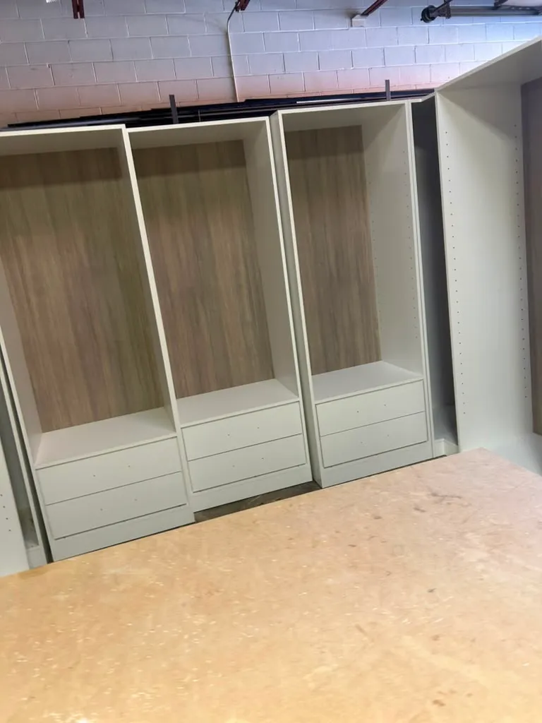 Custom closet cabinetry with warm wood-grain interior paneling