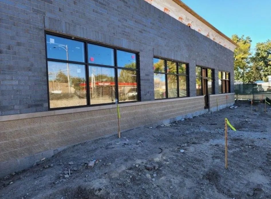 Storefront window glazing on a commercial building under construction