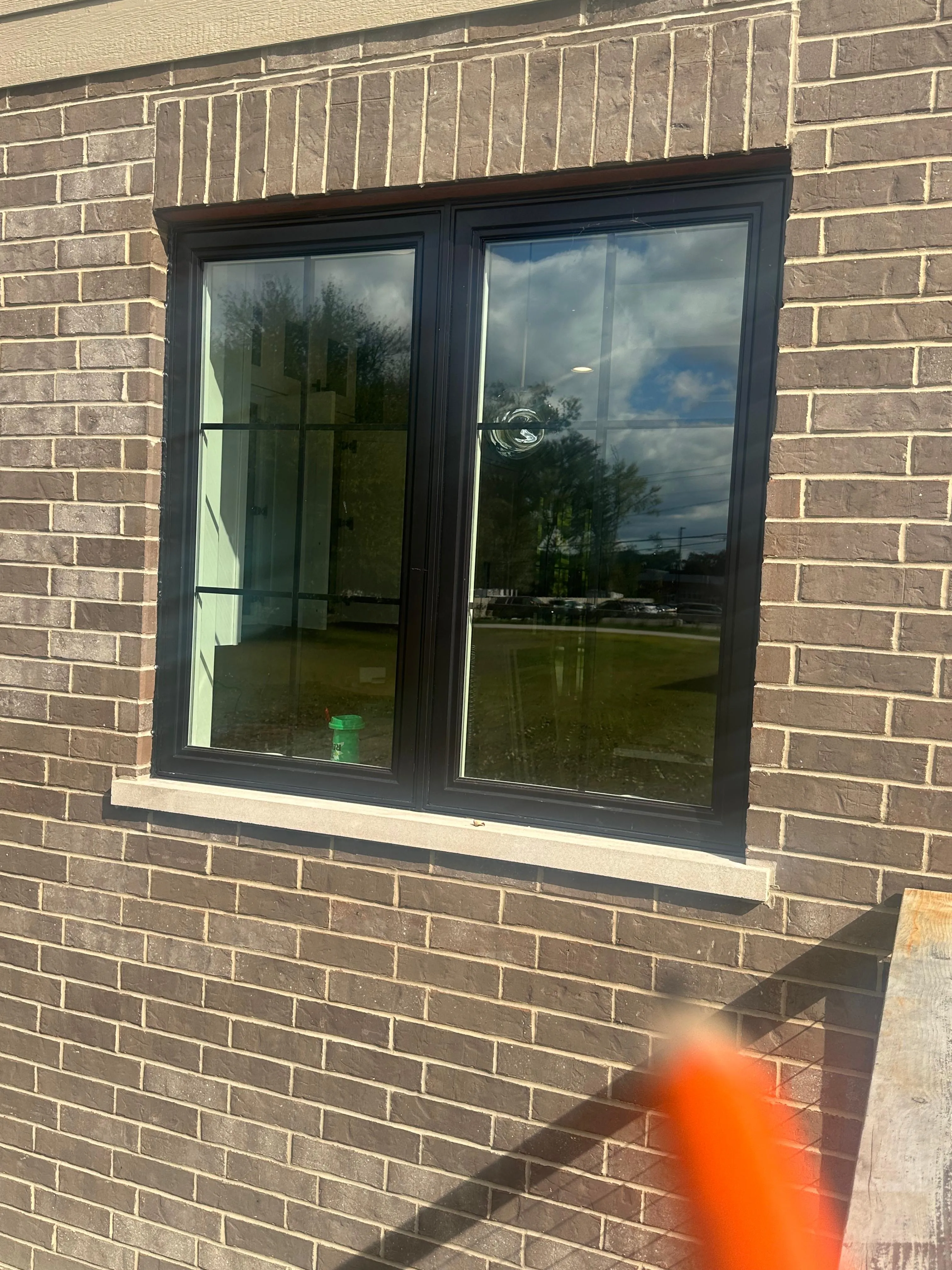 Black-frame casement windows on a commercial brick building