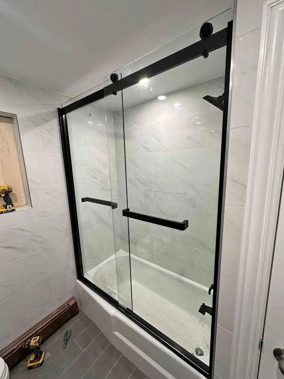 Black-frame sliding tub and shower glass door