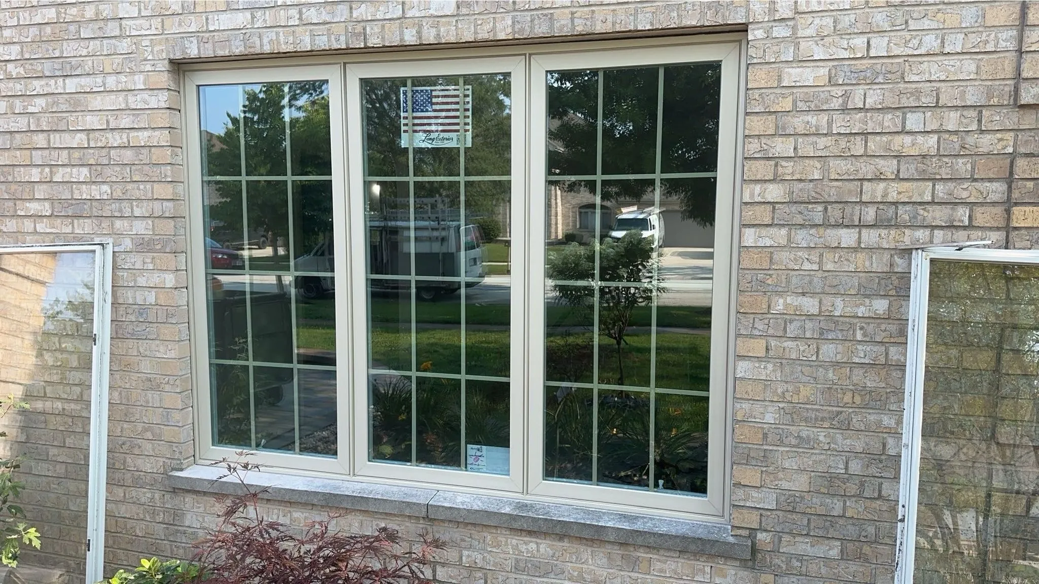 Triple window installation on a brick residential home