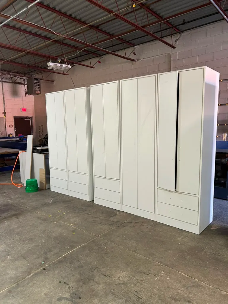 Row of custom closet wardrobe cabinets built in the workshop